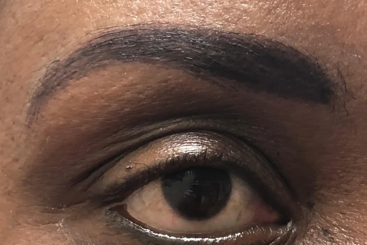 After: the same eye and brow immediately after the procedure, with a full, dark, shaded brow